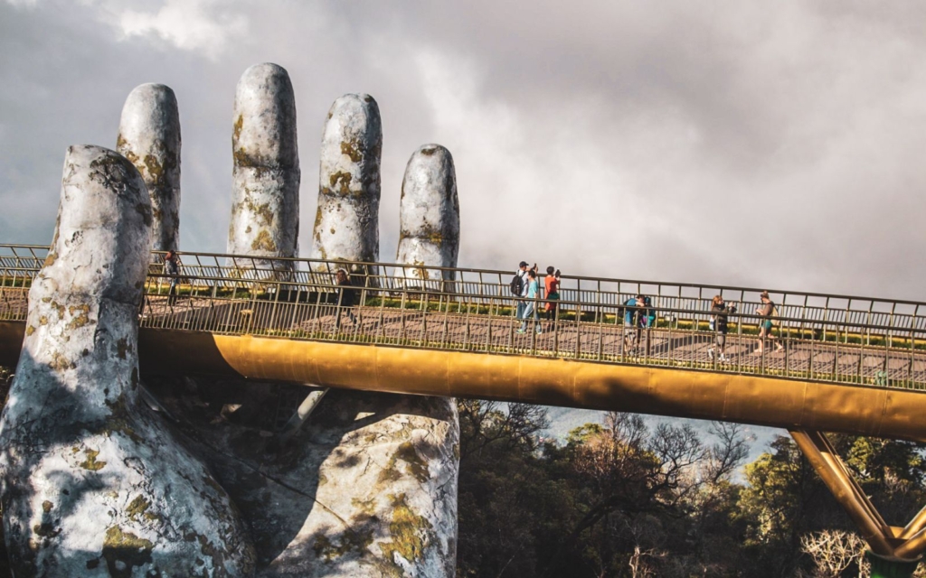 Golden Bridge with large stone hand against a gray cloudy sky, one of the must-visit sites on a Da Nang itinerary