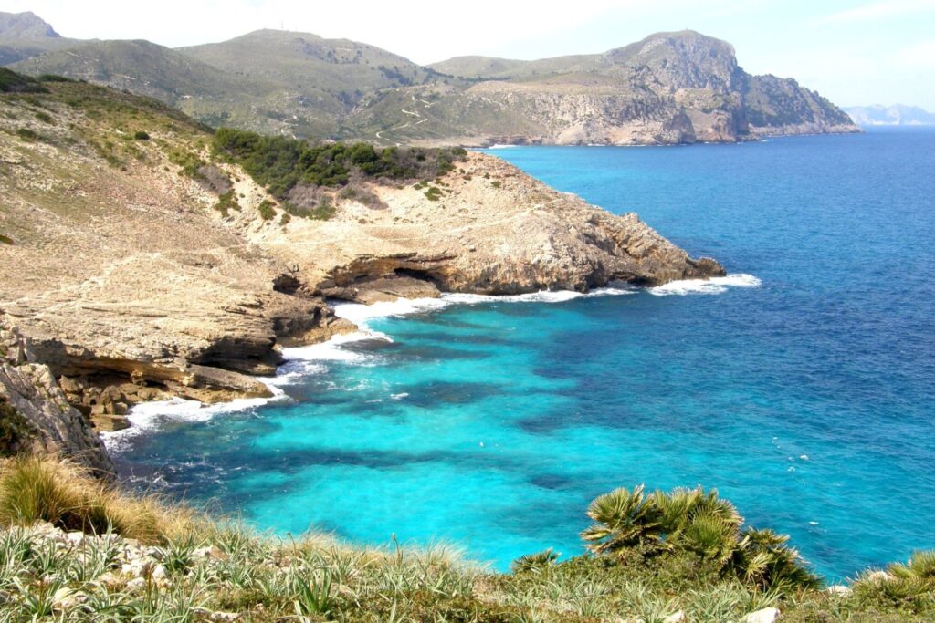 panoramic view of a blue waters coastline and beautiful mountains and rock formations