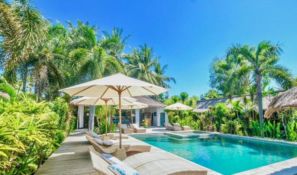tropical outdoor pool with green plants and nature view