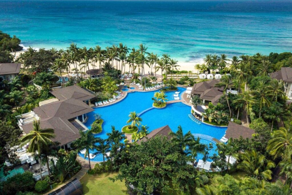 aerial view of outdoor pool and beachfront setting of Movenpick Resort and Spa Boracay