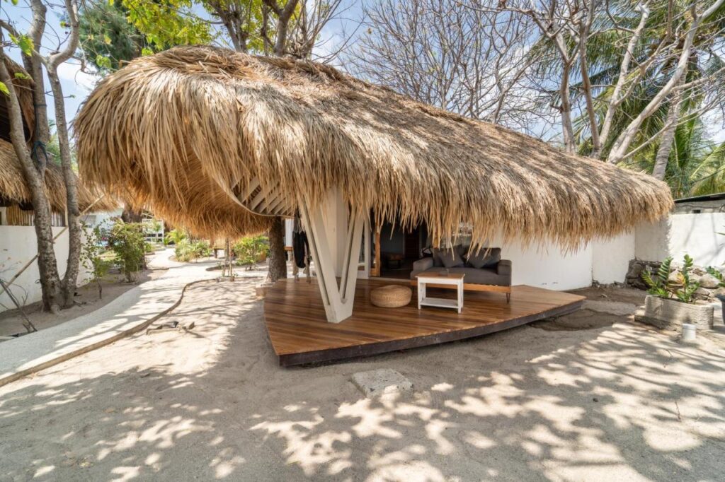 tropical beachfront accommodation with native style roofing