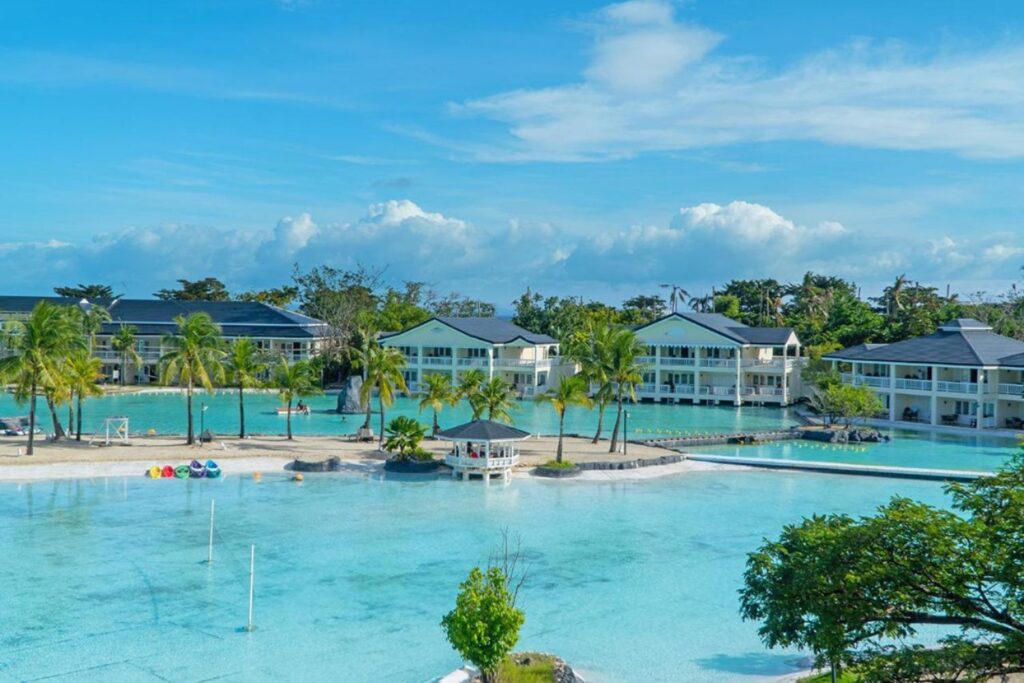 panoramic view of overwater bungalow resorts surrounded by crystal blue waters