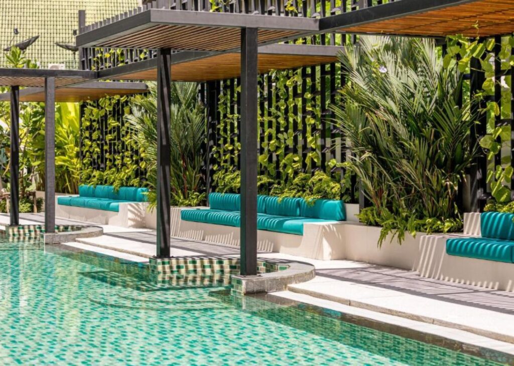 Pool with green tile and greenery at Outrigger Surin Beach