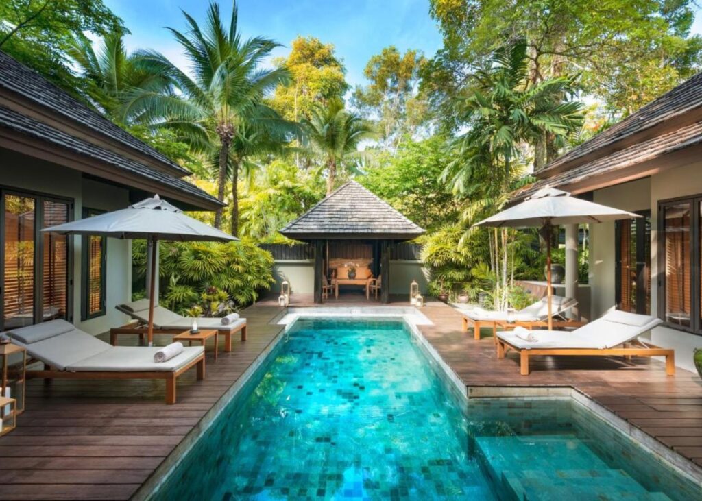 Private pool surrounded by palm trees and teak deck at Anantara Resort in Phuket