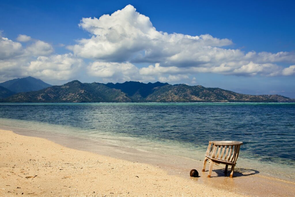 wooden sunbathing chair at Sunset Beach