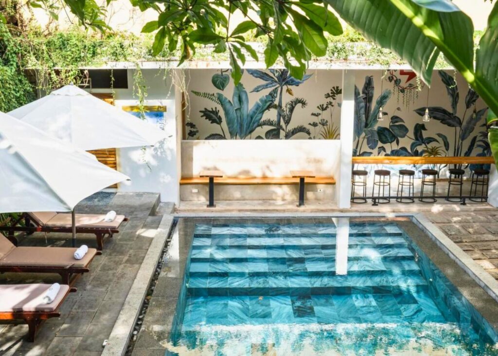 Swimming pool surrounded by greenery at 9Station Hostel